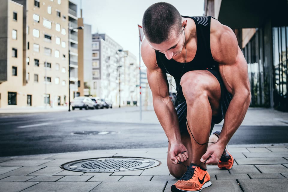 Runner tying a shoe before exercise