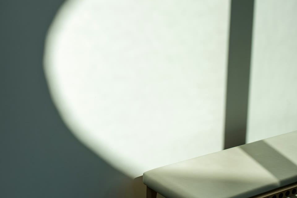 Sunlight falling across a massage table in a calm room