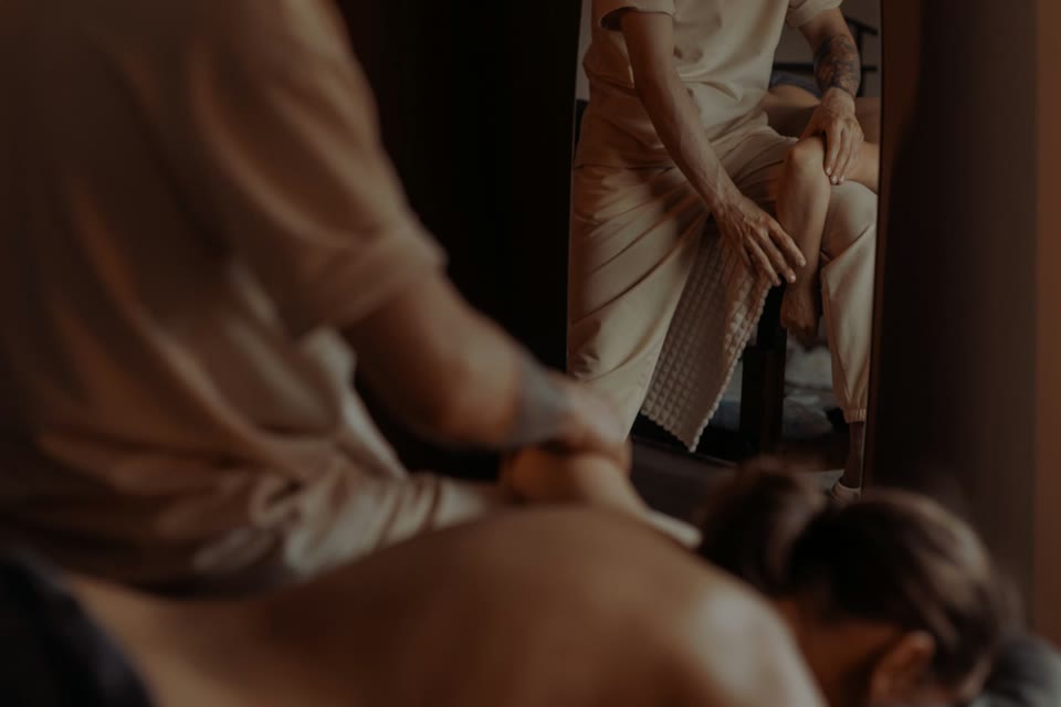 Massage therapist working gently on a client's lower leg
