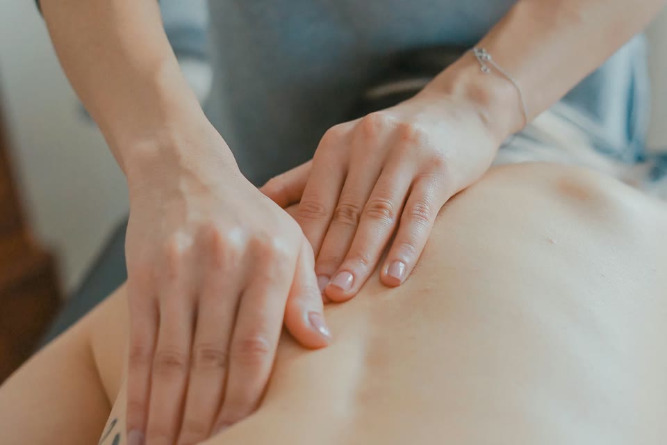 Hands applying firm pressure during a back massage